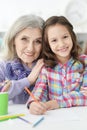 Portrait of little girl drawing with her grandmother Royalty Free Stock Photo