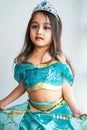 Portrait of a little girl dressed in arabian princess costume against white background. Natural light, selective focus