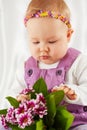 Portrait of little girl dressed in violet pinafore dress