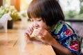 Portrait of little girl eating cookies in the kitchen Royalty Free Stock Photo