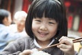 Portrait of little girl eating rice