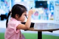 Portrait little girl eating spaghetti carbonara in black box. Side view cute kid having lunch or dinner. Royalty Free Stock Photo