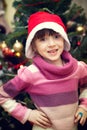 Portrait of little girl in front of Christmas tree Royalty Free Stock Photo