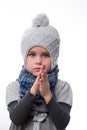 Portrait of a little girl in a hat and scarf on a white background. Royalty Free Stock Photo