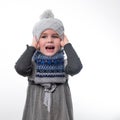 Portrait of a little girl in a hat and scarf on a white background. Royalty Free Stock Photo