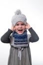 Portrait of a little girl in a hat and scarf on a white background. Royalty Free Stock Photo