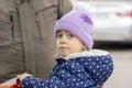 Portrait of a little girl in a hat sitting in a grocery stroller next to her grandfather. Concept: refugees from Ukraine, assistan Royalty Free Stock Photo