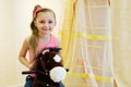 Portrait of little girl on hobbyhorse