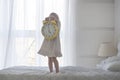 Portrait of little girl holding alarm clock, isolated over white Royalty Free Stock Photo