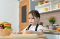 Portrait of a little girl in the kitchen of a house having fun playing with fruit toy Royalty Free Stock Photo