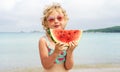 Portrait little girl licking fresh watermelon slice posing on beach having fun and positive emotion Royalty Free Stock Photo