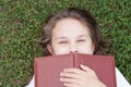 Portrait of a little girl lying on the green grass Royalty Free Stock Photo