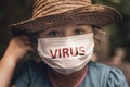 Portrait of a little girl in a medical mask with the inscription Virus. Pandemic coronavirus Covid-19, virus protection