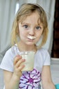 Portrait of a little girl with milk moustaches. Royalty Free Stock Photo