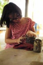 Portrait little girl molds the clay for producing the pottery work in workshop class