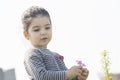 Portrait of a little girl picked some spring flowers in hands