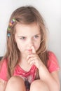 A portrait of a little girl picking her nose Royalty Free Stock Photo