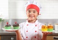 Portrait of a little girl with plates of muffins Royalty Free Stock Photo