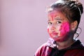 Portrait of Little Girl playing with Colors. Holi concept India