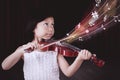 Girl playing melody with violin on the stage