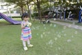 Little girl playing with soap bubbles in the park Royalty Free Stock Photo