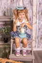 Portrait of little girl in retro vintage photographic studios