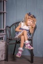 Portrait of little girl in retro vintage photographic studios