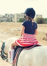 Portrait of little girl riding pony. Royalty Free Stock Photo