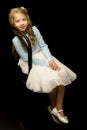 Portrait of a little girl sitting on an old Viennese chair, blac Royalty Free Stock Photo