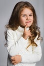 Portrait of little girl thinking, over a gray Royalty Free Stock Photo