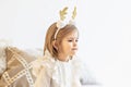 Portrait of a little girl Toddler with a headband on her head in the form of deer horns. Christmas holidays.Light and bright Royalty Free Stock Photo