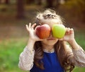 Portrait of a little girl with two large apples Royalty Free Stock Photo