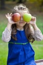 Portrait of a little girl with two large apples Royalty Free Stock Photo