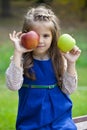 Portrait of a little girl with two large apples Royalty Free Stock Photo