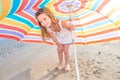 Portrait of a little girl with an umbrella on the beach Royalty Free Stock Photo