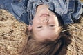 Portrait of a little girl upside down on a haystack Royalty Free Stock Photo