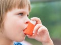 Portrait of little girl using asthma inhaler outdoors Royalty Free Stock Photo