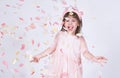 Portrait of little girl wearing pink dress in tulle with princess crown on head on white background enjoy confetti Royalty Free Stock Photo