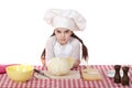 Portrait of a little girl in a white apron and chefs hat shred c Royalty Free Stock Photo