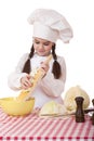 Portrait of a little girl in a white apron and chefs hat shred c Royalty Free Stock Photo