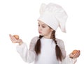 Portrait of a little girl in a white apron holding two chicken e Royalty Free Stock Photo