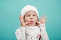 Portrait of a little girl in white hat and scarf Royalty Free Stock Photo