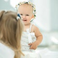 Portrait of a little girl in wreath of daisies