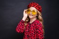 Portrait little girl in yellow glasses in red dress with hearts and red beret Royalty Free Stock Photo