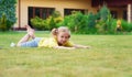 Portrait of little happy girl playing barefoot badminton at garden near her house Royalty Free Stock Photo