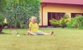 Portrait of little happy girl playing barefoot badminton at garden near her house Royalty Free Stock Photo