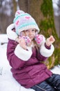 Portrait of little happy girl in the snow sunny Royalty Free Stock Photo