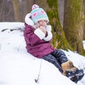 Portrait of little happy girl in the snow sunny Royalty Free Stock Photo