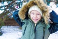 Portrait of little happy girl in snow sunny winter Royalty Free Stock Photo