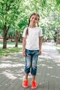 Portrait of a little happy girl in a white T-shirt in park Royalty Free Stock Photo